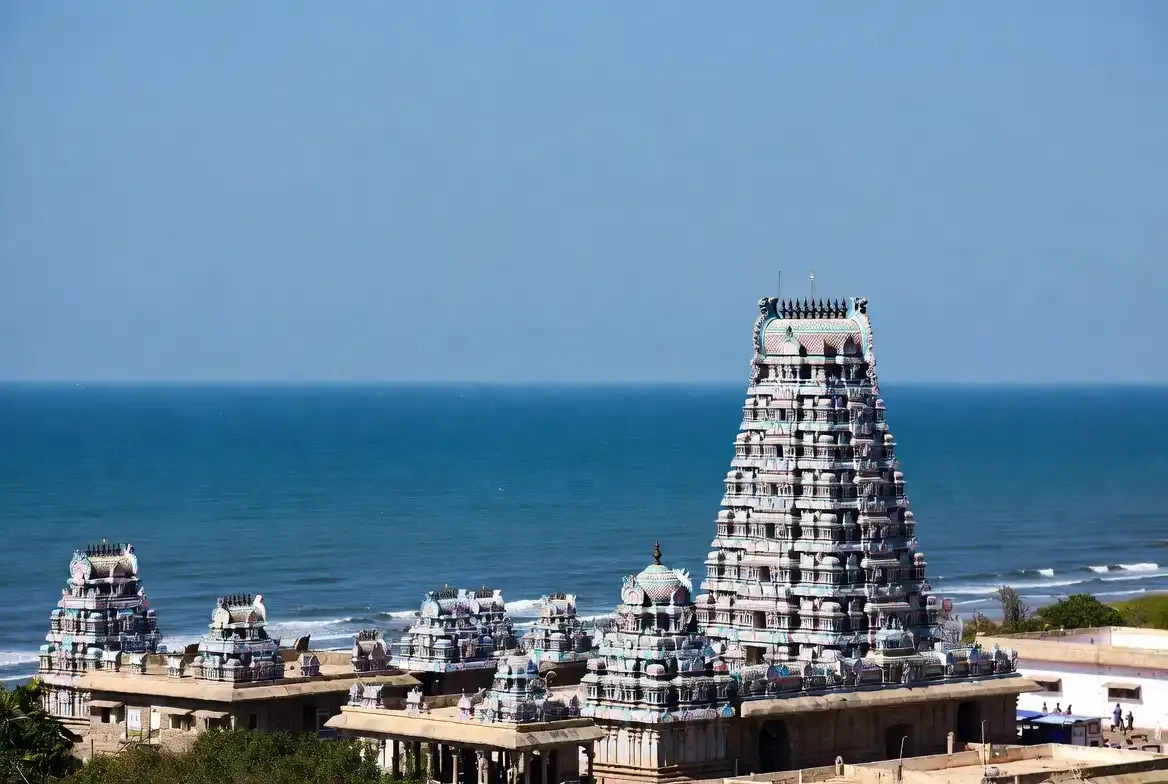 The striking sea-facing structure of the Tiruchendur Subramania Swamy Temple against the waves of the ocean.